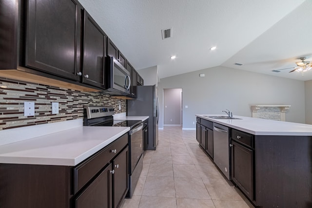 kitchen with light tile patterned floors, stainless steel appliances, a sink, visible vents, and light countertops