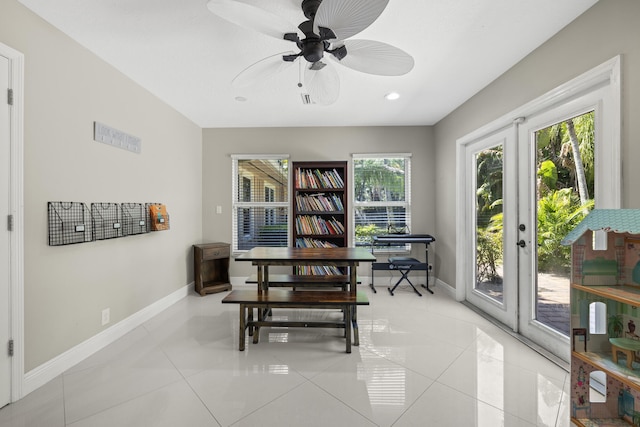 dining room with a ceiling fan, light tile patterned flooring, french doors, and baseboards