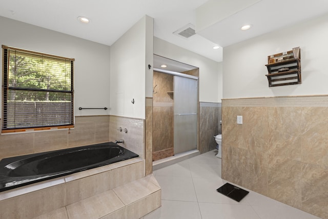 bathroom with visible vents, tile patterned flooring, a shower stall, a garden tub, and toilet