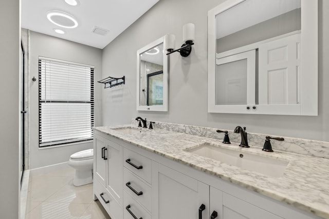 bathroom featuring tile patterned floors, visible vents, toilet, and a sink