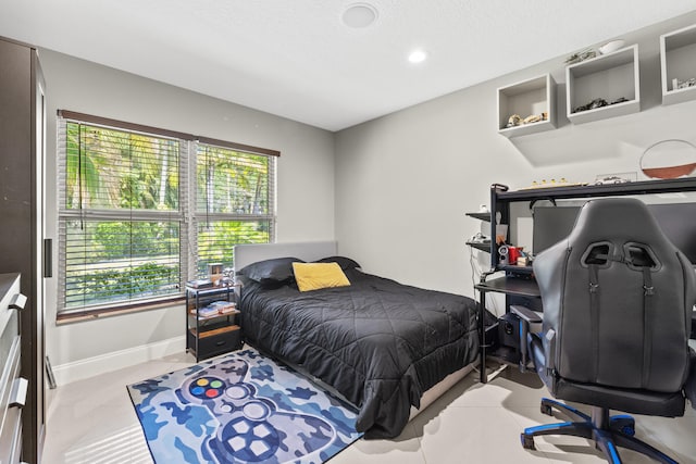 bedroom featuring tile patterned floors and baseboards