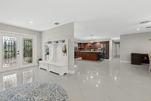 foyer with light tile patterned floors, visible vents, recessed lighting, and baseboards