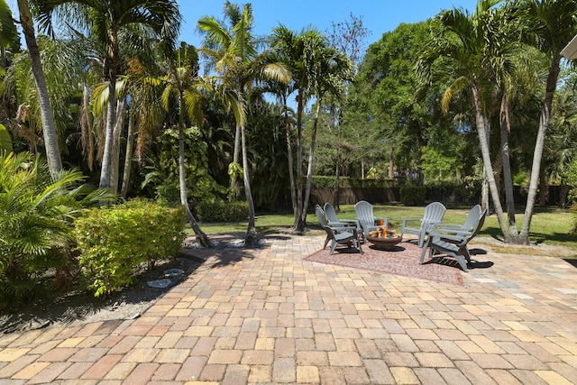 view of patio featuring fence and an outdoor fire pit