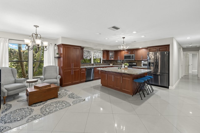 kitchen featuring light tile patterned floors, visible vents, stainless steel appliances, and a chandelier