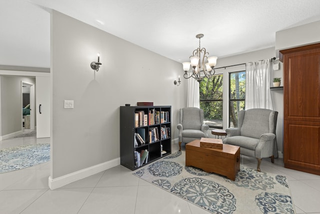 living area featuring light tile patterned floors, an inviting chandelier, and baseboards