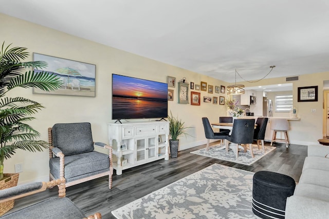 living room with baseboards, visible vents, and dark wood finished floors