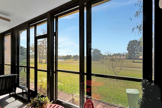 sunroom featuring a rural view