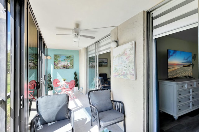 sunroom / solarium with a ceiling fan