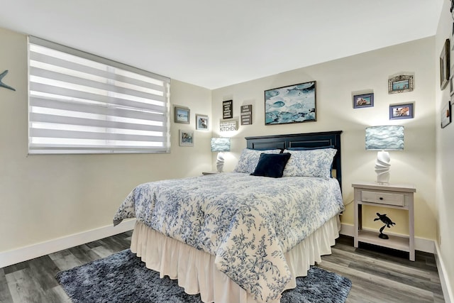 bedroom featuring wood finished floors and baseboards