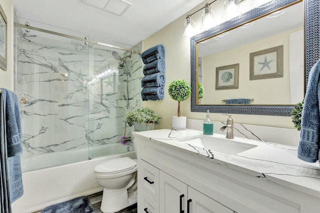 bathroom with visible vents, bath / shower combo with glass door, toilet, wood finished floors, and vanity