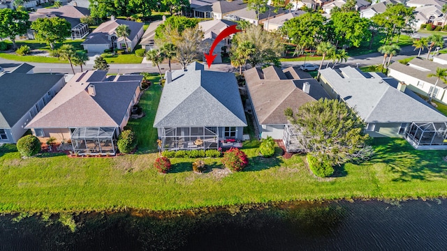 birds eye view of property featuring a water view and a residential view