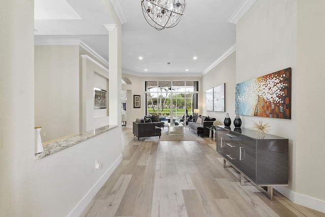 corridor featuring baseboards, ornamental molding, light wood-style floors, a chandelier, and recessed lighting