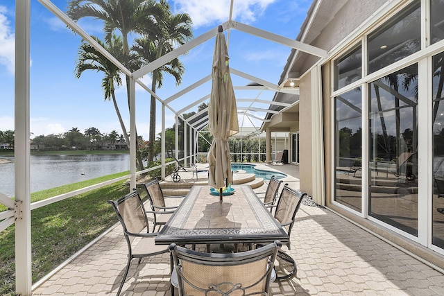 sunroom / solarium with a water view