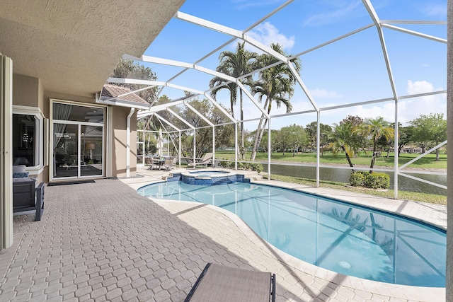 view of swimming pool with a lanai, a pool with connected hot tub, and a patio