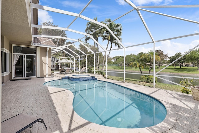 view of pool featuring a pool with connected hot tub, glass enclosure, and a patio