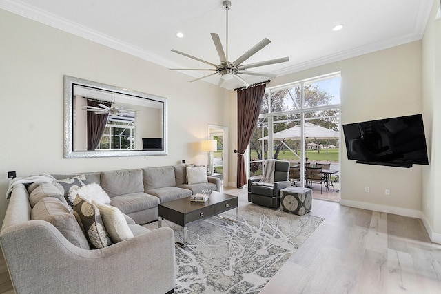 living room featuring crown molding, baseboards, a ceiling fan, and wood finished floors