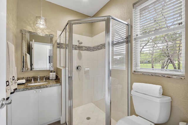 full bath featuring toilet, a stall shower, vanity, and a textured wall