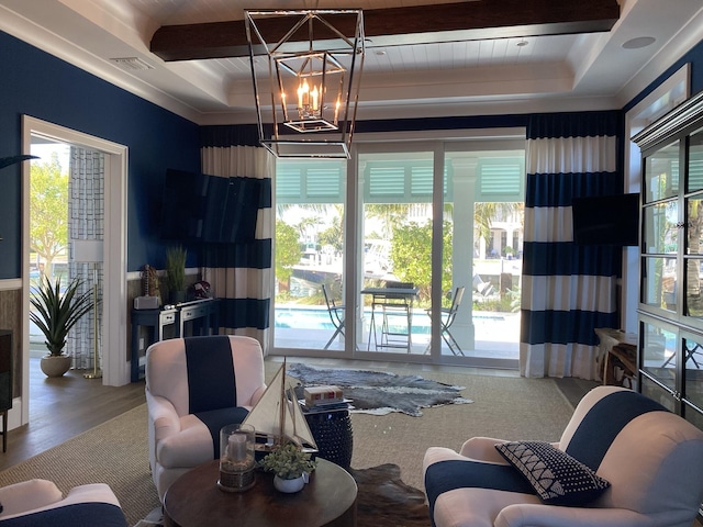 living room with beam ceiling, a healthy amount of sunlight, and visible vents