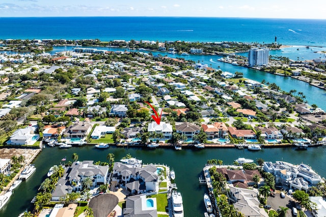 drone / aerial view featuring a water view and a residential view