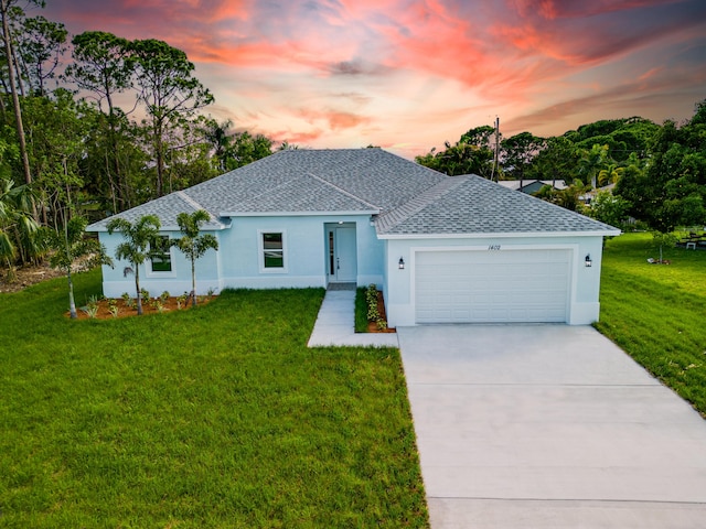 ranch-style home with a front lawn, roof with shingles, driveway, and an attached garage