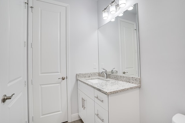 bathroom with toilet and vanity