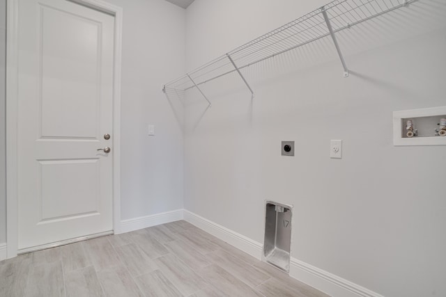 clothes washing area with laundry area, baseboards, washer hookup, and electric dryer hookup