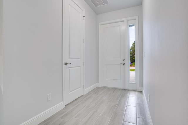 foyer entrance featuring visible vents and baseboards