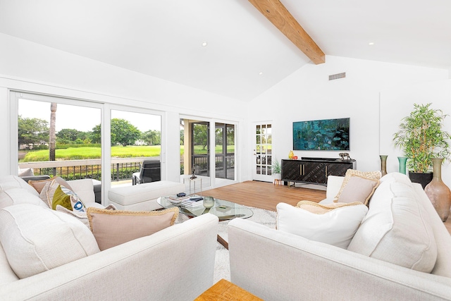 living room featuring beamed ceiling, wood finished floors, visible vents, and high vaulted ceiling