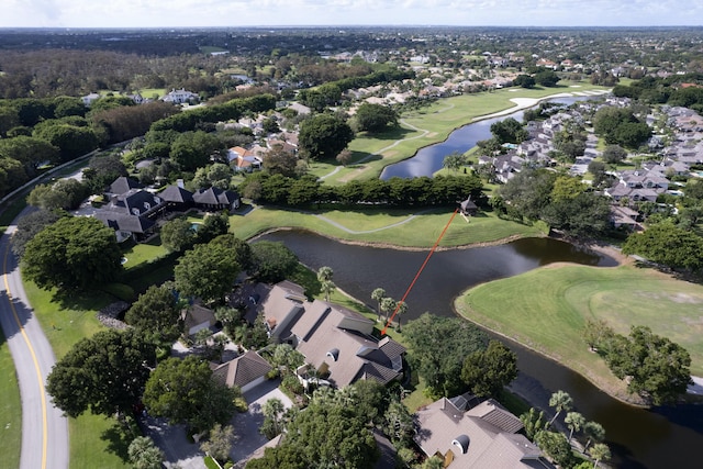 aerial view with view of golf course, a water view, and a residential view