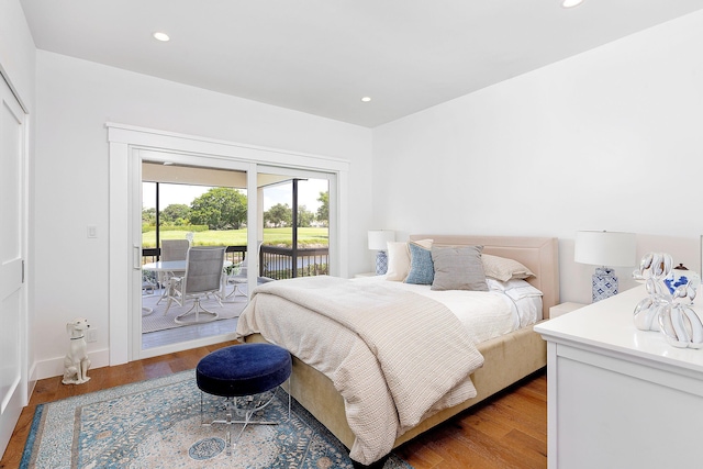 bedroom featuring recessed lighting, wood finished floors, and access to exterior