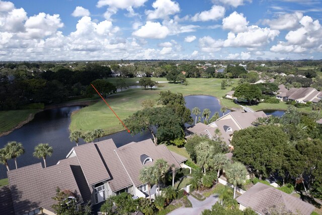 drone / aerial view with a water view and view of golf course