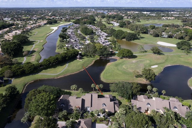 birds eye view of property with view of golf course, a water view, and a residential view