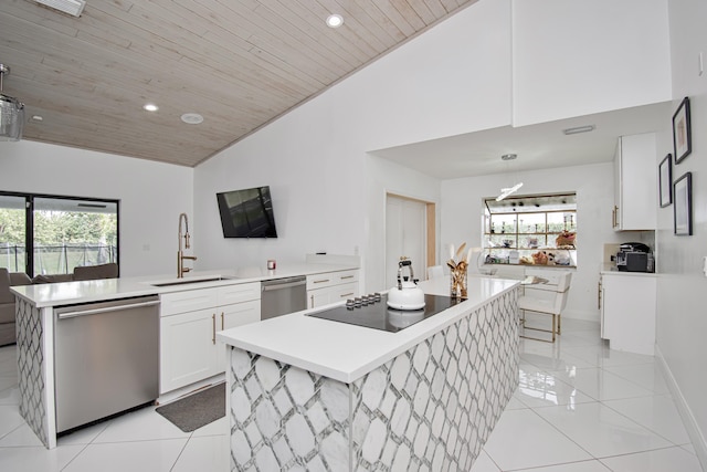 kitchen featuring a sink, black electric stovetop, stainless steel dishwasher, and light tile patterned flooring