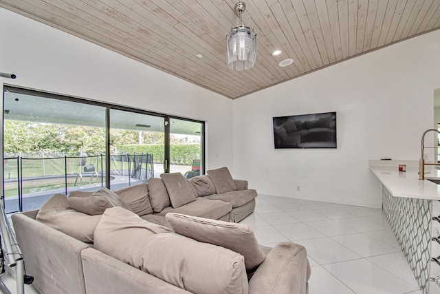 living area with lofted ceiling, light tile patterned flooring, wood ceiling, and baseboards