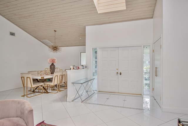 tiled foyer entrance featuring visible vents, wood ceiling, and vaulted ceiling