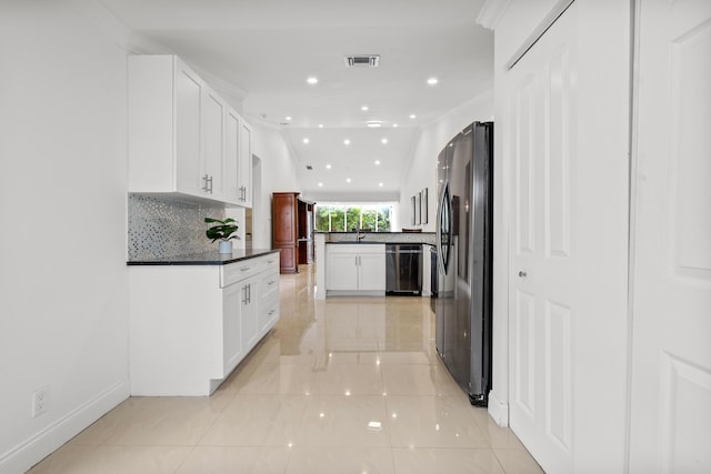 kitchen with dark countertops, visible vents, stainless steel appliances, and backsplash