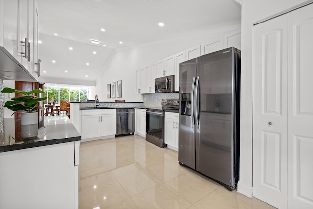 kitchen with white cabinets, appliances with stainless steel finishes, backsplash, and a sink