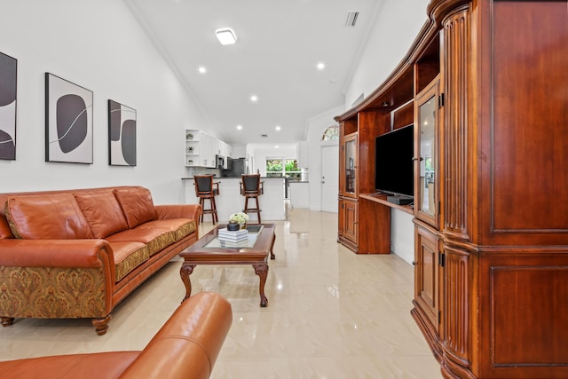 living area with ornamental molding, recessed lighting, marble finish floor, and visible vents