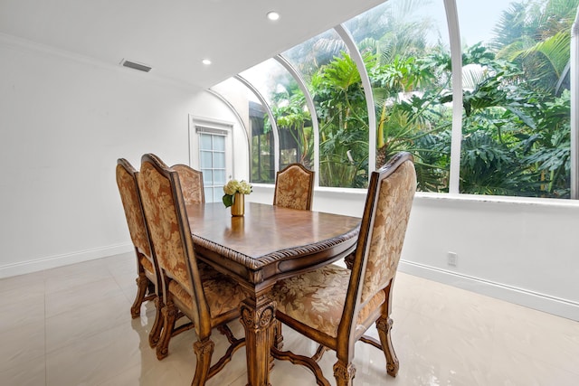 dining space with recessed lighting, a sunroom, visible vents, baseboards, and ornamental molding