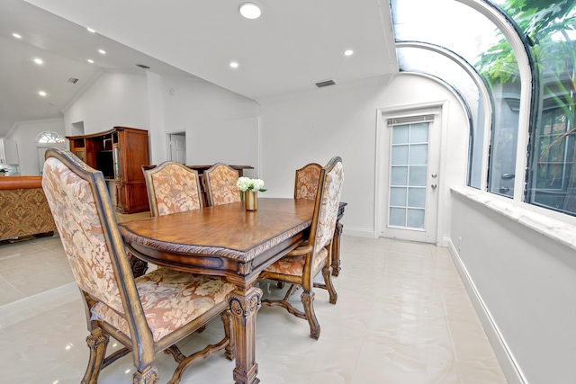 dining space with lofted ceiling, baseboards, visible vents, and recessed lighting