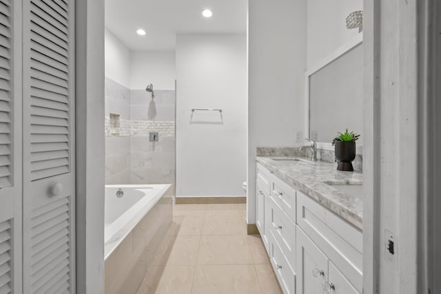 full bathroom with tiled shower, a closet, a sink, and a washtub