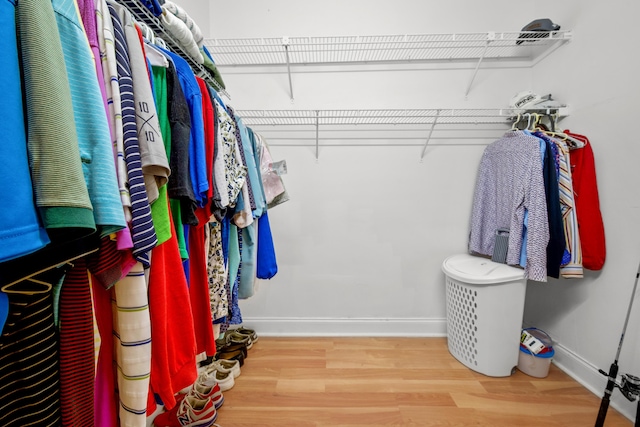 walk in closet featuring wood finished floors