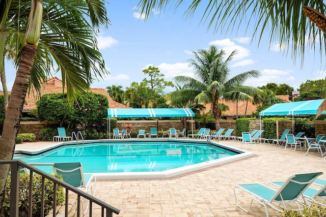 pool featuring a patio area and fence