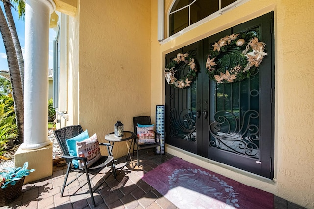 entrance to property with stucco siding and french doors