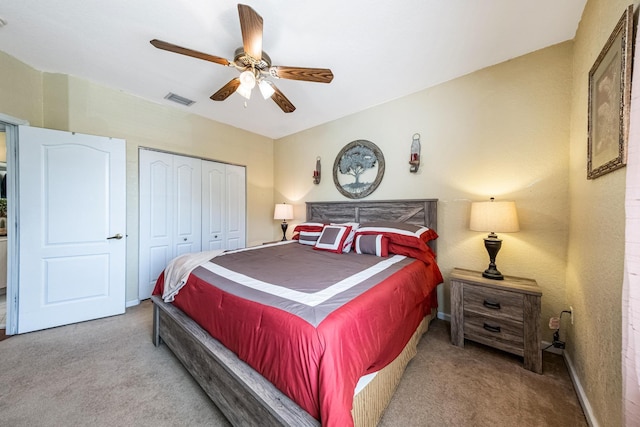 bedroom with a ceiling fan, visible vents, baseboards, a closet, and carpet flooring