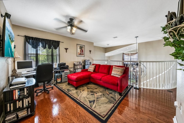 office space with visible vents, ceiling fan, and wood finished floors