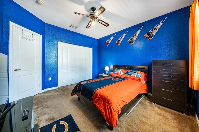 bedroom featuring a closet, a textured wall, and carpet floors