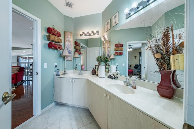 ensuite bathroom featuring visible vents, double vanity, tile patterned floors, ensuite bath, and a sink