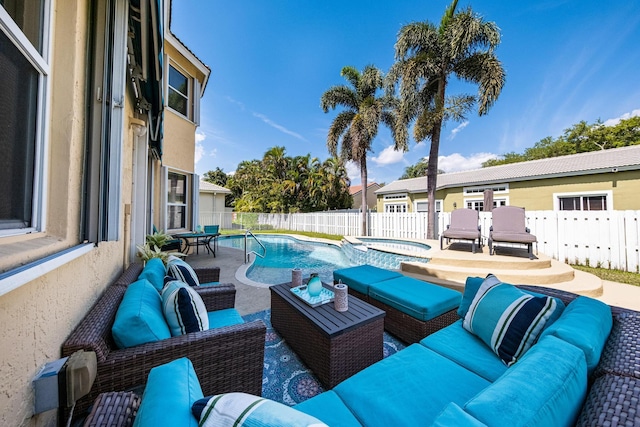 view of patio with an outdoor living space, a fenced in pool, an in ground hot tub, and a fenced backyard