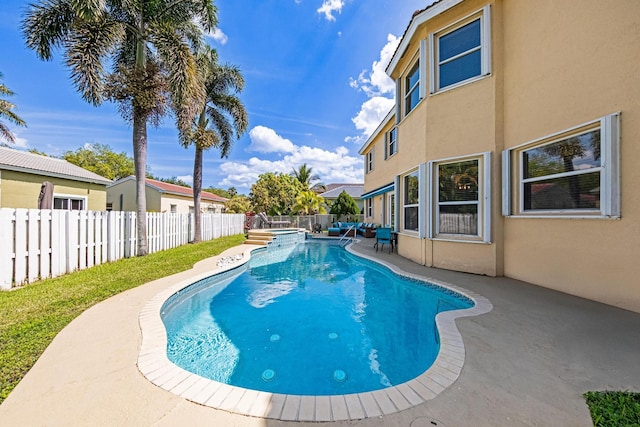 view of pool with a patio, a pool with connected hot tub, and a fenced backyard